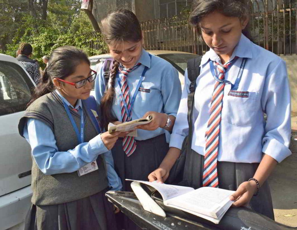 Students appearing for CBSE class 12th Board examination revising the subject just before the Examination begins at a centre, in New Delhi. Photo: UNI
