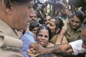 Police forcibly removing Prannoy’s mother, demanding a fair probe, in Thiruvananthapuram. Photo: UNI