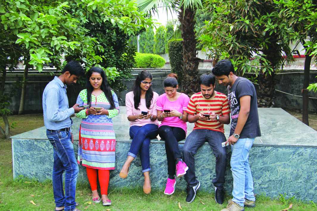 Youngsters hooked to smartphones. Photo: Bhavana Gaur