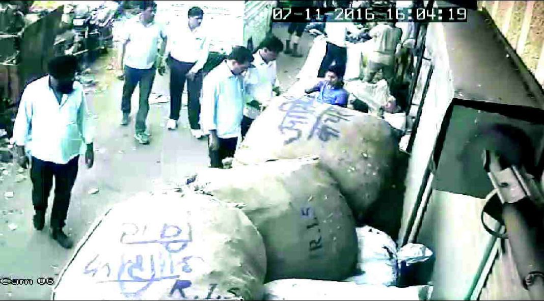 CCTV footage shows Mursalin Malik and Asif Malik being questioned by five policemen outside their shop in Seelampur