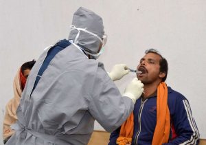 A doctor examines a patient for swine flu at Patna Medical College and Hospital. Photo: UNI