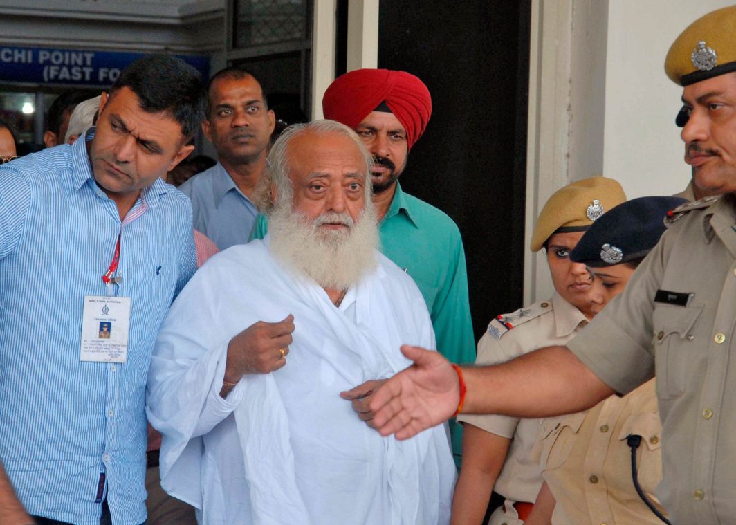 Asaram Bapu (Centre) outside an airport after his arrest in Jodhpur, on September 1, 2013Photo UNI
