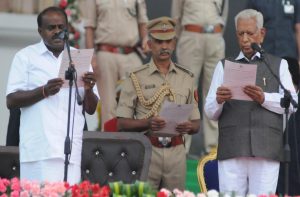 Karnataka Governor Vajubhai Vala (right) administering the oath to HD Kumaraswamy at the swearing-in ceremony