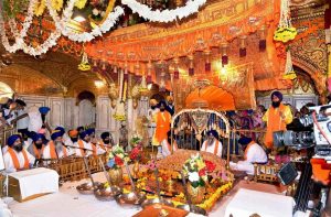 Granthis with the Shri Guru Granth Sahib in the inner sanctum sanctorum of the Golden Temple in Amritsar