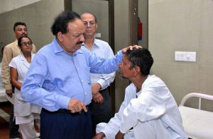 Former Union Health Minister Dr Harsh Vardhan interacting with a leprosy patient/Photo: UNI