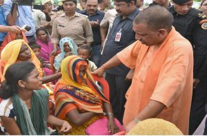 UP CM Yogi Adityanath meets the victims’ families in Sonbhadra/Photo: UNI