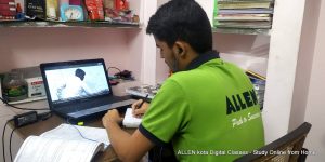 student attending an online class through a computer