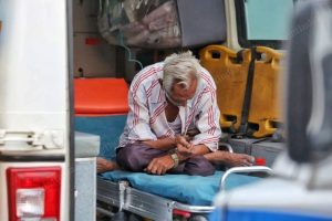 covid-19 victim waits outside the hospital in an ambulance