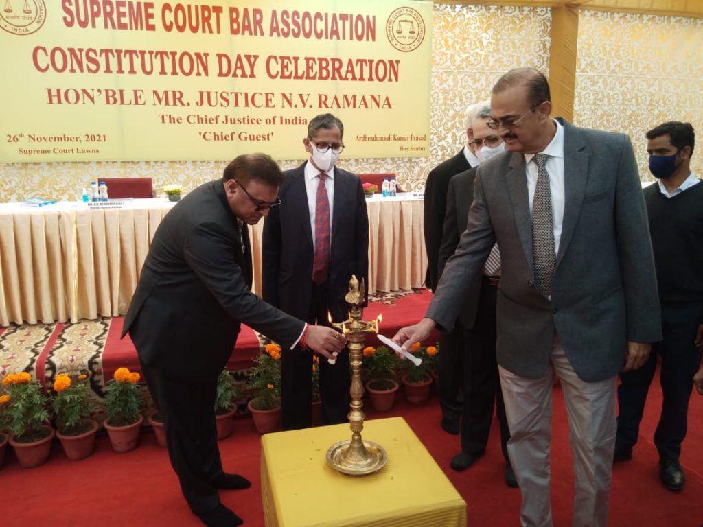 Senior Advocate Pradeep Rai, SCBA Vice President (left) and Senior Advocate Vikas Singh, the SCBA President, light the lamp at the event with CJI Ramana and Justice Khanwilkar looking on.