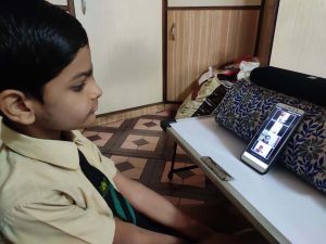 student attending online class at home