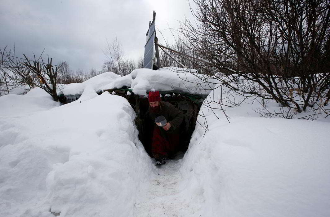 HIDEY HOLE: Yury Alekseyev, a former lawyer from Moscow who is called a “Russian hobbit”, leaves his underground home in the forest on the side of the road northeast from Moscow, Russia, February 3, Reuters/UNI