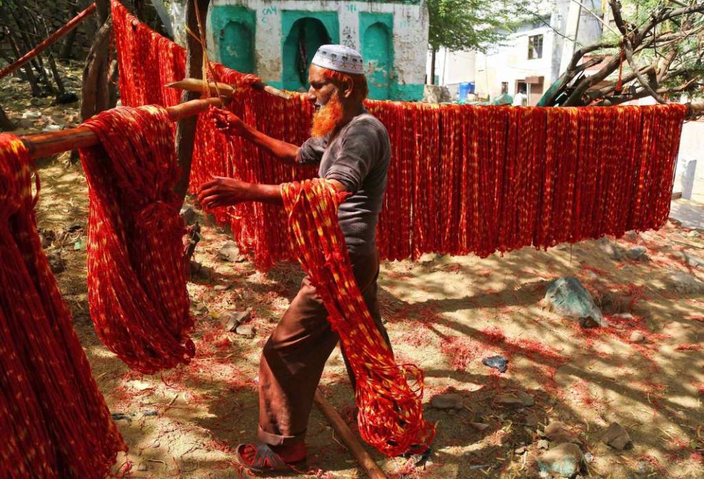 TO DYE FOR: A worker hangs kalavas or sacred threads to dry after dyeing them with colours in Ajmer, Reuters/UNI
