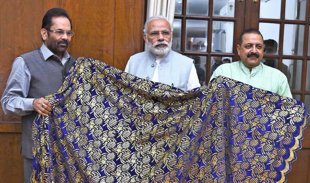 DEVOTION BY AIR: Prime Minister Narendra Modi hands over a chaadar to be offered at Dargah Khwaja Moinuddin Chishti’s dargah at Ajmer Sharif to Minister of State for Minority Affairs (Independent Charge) and Parliamentary Affairs Mukhtar Abbas Naqvi and Minister of State for Development of North Eastern Region), Prime Minister’s Office, Personnel, Public Grievances Jitendra Singh, in New Delhi, UNI