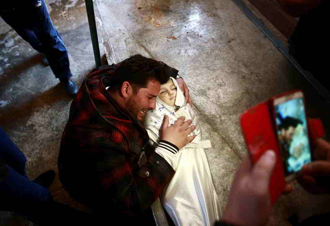 UNSPEAKABLE LOSS: A man grieves for his daughter following an airstrike on the rebel-held besieged city of Douma, in the eastern Damascus suburb of Ghouta, Syria, Reuters/UNI