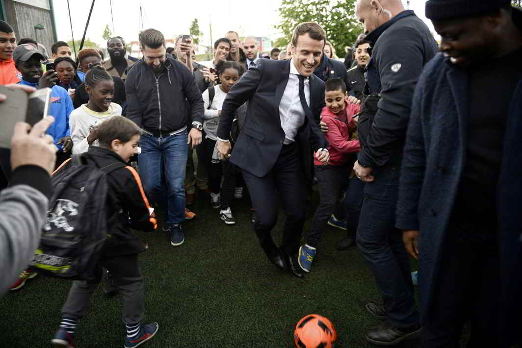 ONWARD: Emmanuel Macron, head of the political movement En Marche! and candidate for the 2017 presidential election, kicks a soccer ball during a campaign visit in Sarcelles, near Paris, Reuters/UNI