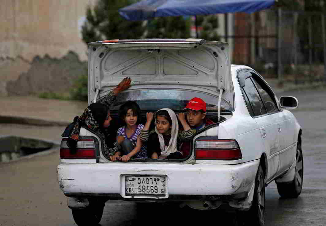 A SEPARATE PEACE: Children ride in the trunk of a car in Kabul, Afghanistan, Reuters/UNI