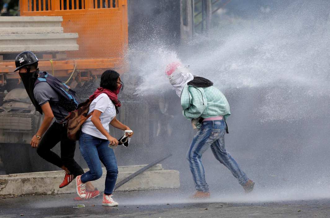 REVOLUTIONARIES: Demonstrators clash with riot security forces while rallying against Venezuela's President Nicolas Maduro's Government in Caracas, Reuters/UNI