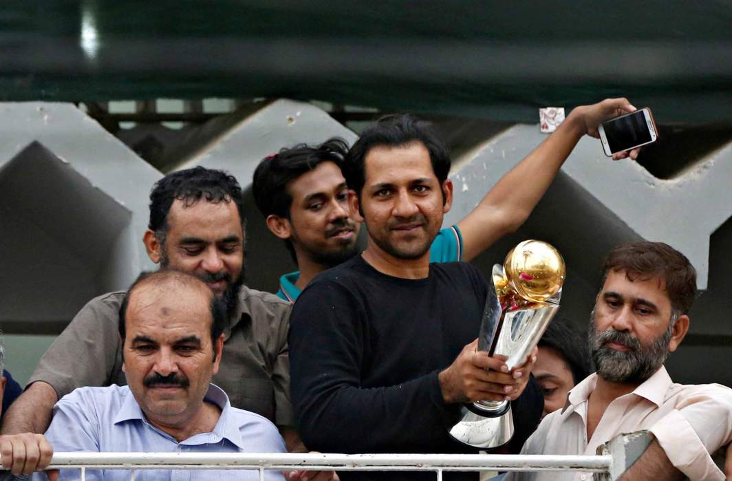 HERO’S WELCOME: Pakistan's Sarfraz Ahmed stands with friends and family members as he celebrates winning the ICC Champions Trophy upon his arrival at his house in Karachi, Pakistan, Reuters/UNI