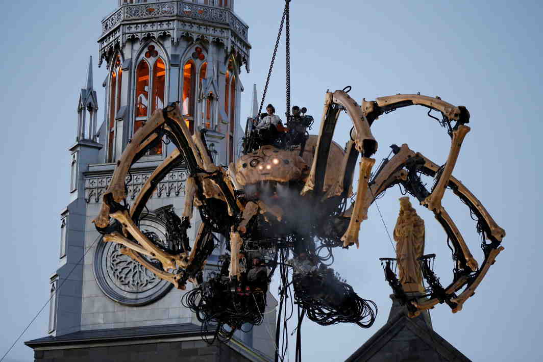 BITE ME: The giant mechanical spider Kumo, created by French production company La Machine, is lowered in front of the Notre-Dame Cathedral Basilica during a performance in Ottawa, Canada, Reuters/UNI