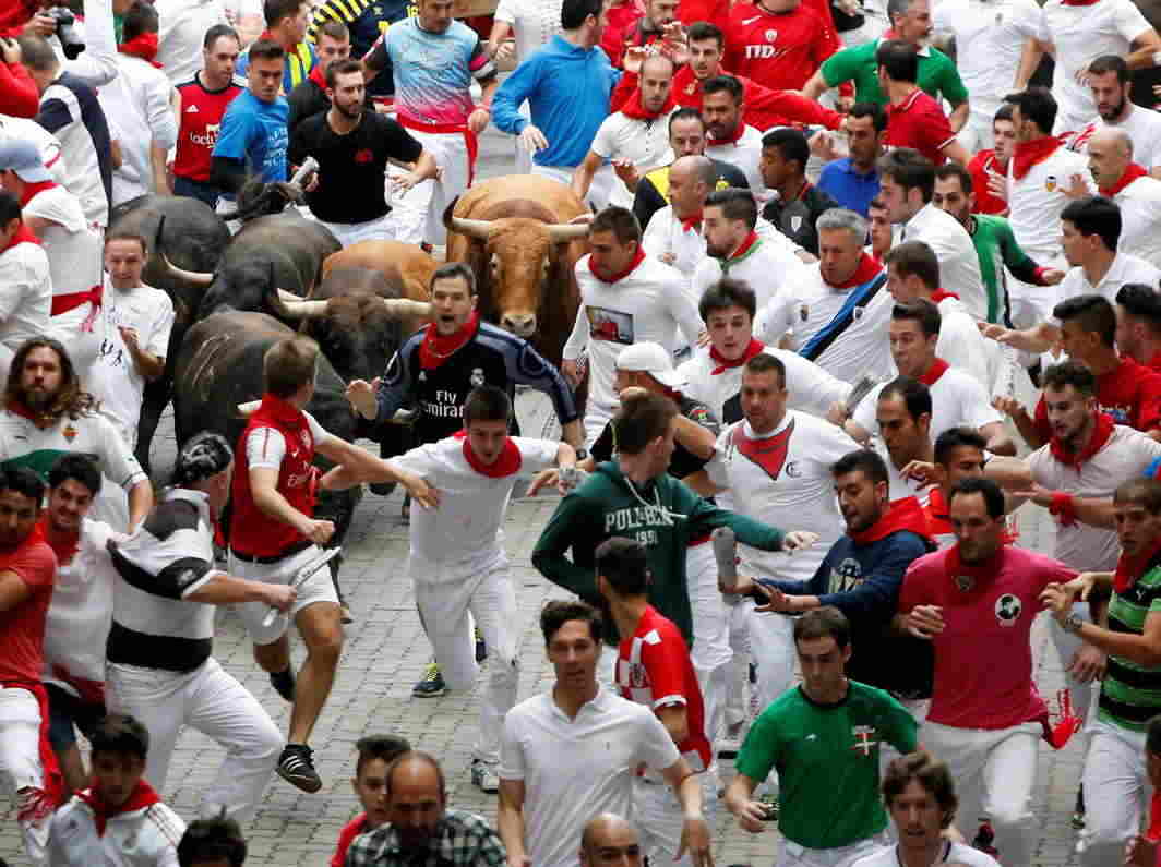 FIND YER MOJO: Runners sprint ahead of bulls during the seventh running of the bulls at the San Fermin festival in Pamplona, northern Spain, Reuters/UNI