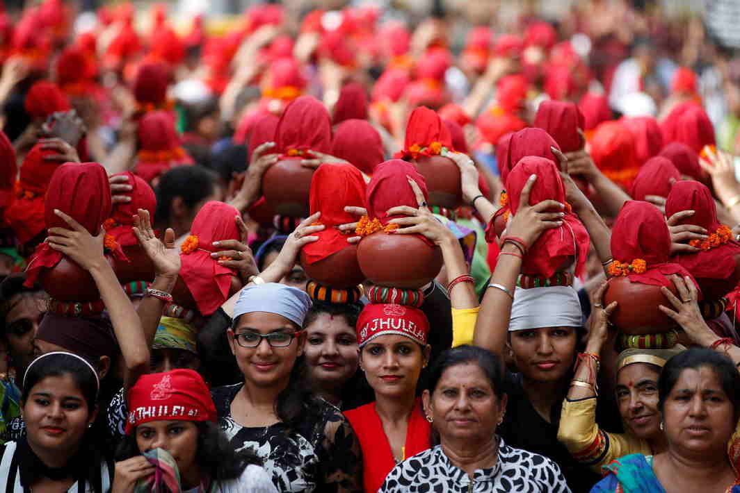 RED BRIGADE: Devotees carry clay water pots as they take part in a procession marking the end of Jhule Lal Chaliha, a 40-day-long fasting festival of the Sindhi community, in Ahmedabad, Reuters/UNI