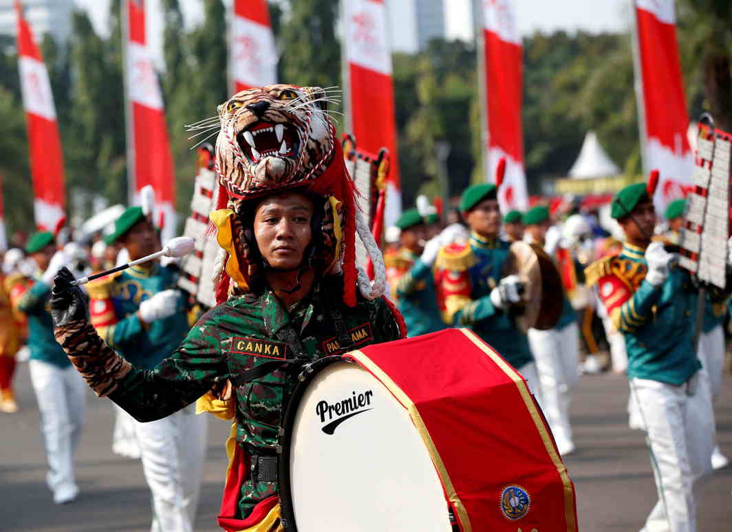 PROUD COLOURS: A military band marches towards the Presidential Palace from the National Monument during Independence Day celebrations in Jakarta, Indonesia, reuters/UNI