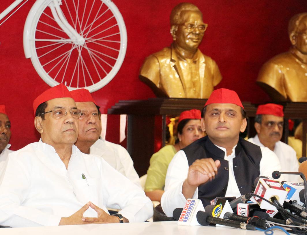 RED CAPS: Samajwadi Party president Akhilesh Yadav addresses a press conference in Lucknow, UNI