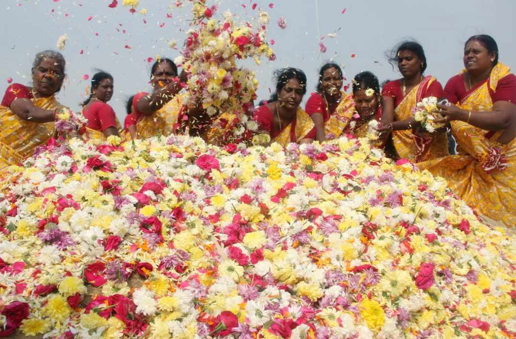 ETCHED IN MEMORY: Women offer floral tribute to tsunami victims on the 13th year of the disaster, in Chennai, UNI