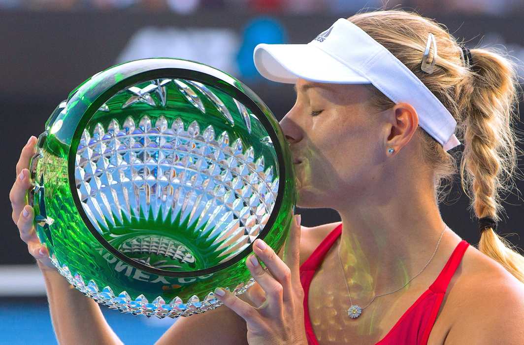 IN FIGHTING FORM: Germany's Angelique Kerber kisses the trophy after winning the final of the Sydney International Tournament against Australia's Ashleigh Barty, Reuters/UNI