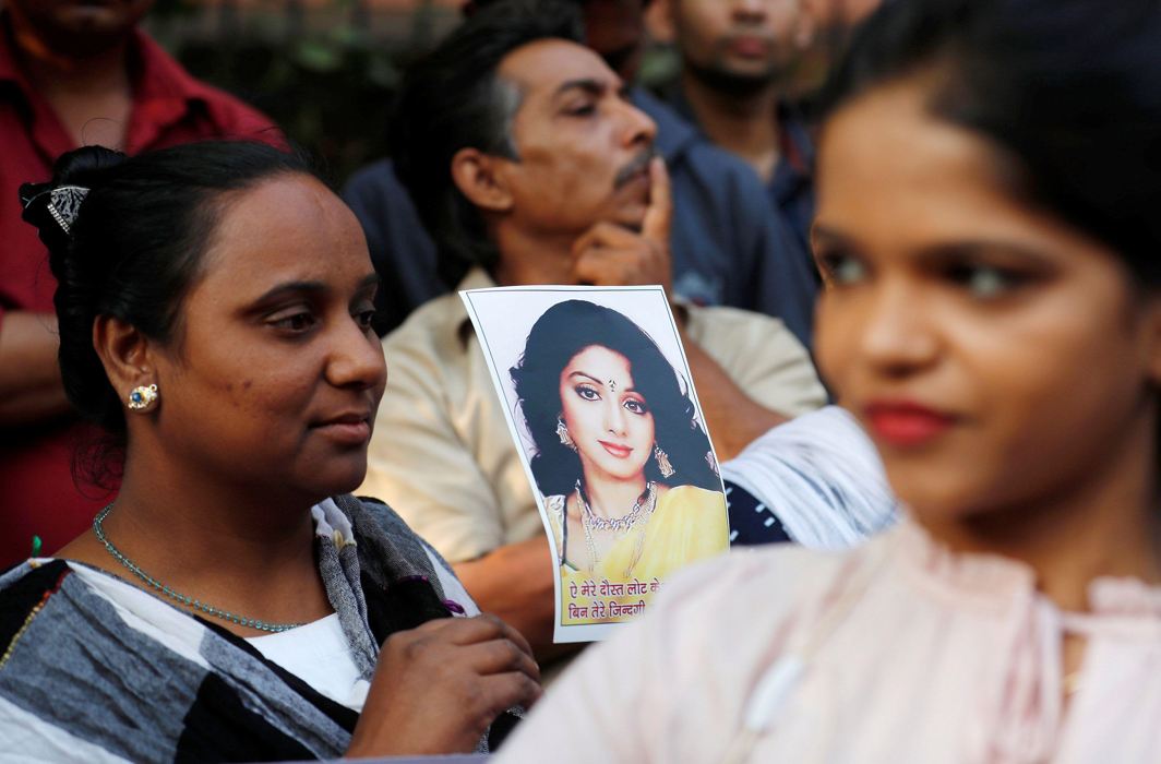 DIVA IN THE SKY: Fans of of Bollywood actress Sridevi hold her portrait as they wait to offer their condolences outside a makeshift memorial in Mumbai, India, Reuters/UNI