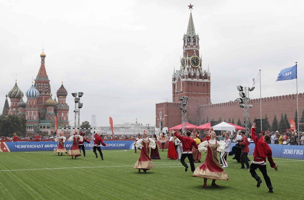 Performers in traditional costumes dance after an exhibition match between teams of footballing legends in the World Cup Football Park in Red Square in central Moscow, Russia, Reuters/UNI