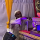 Muslim man putting money into donation booth