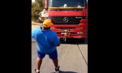Man pulling truck with his teeth