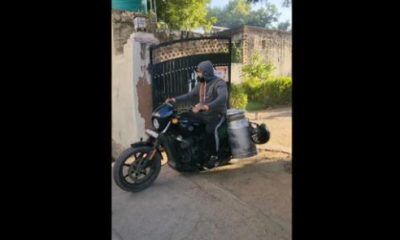 man delivering milk on a Harley Davidson