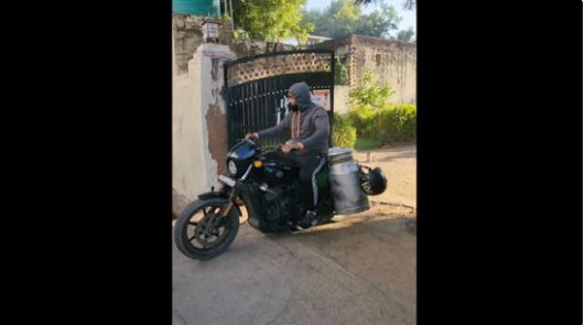 man delivering milk on a Harley Davidson
