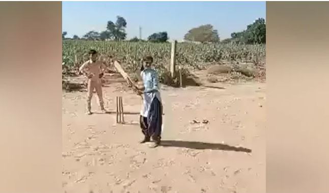 Village girl playing cricket