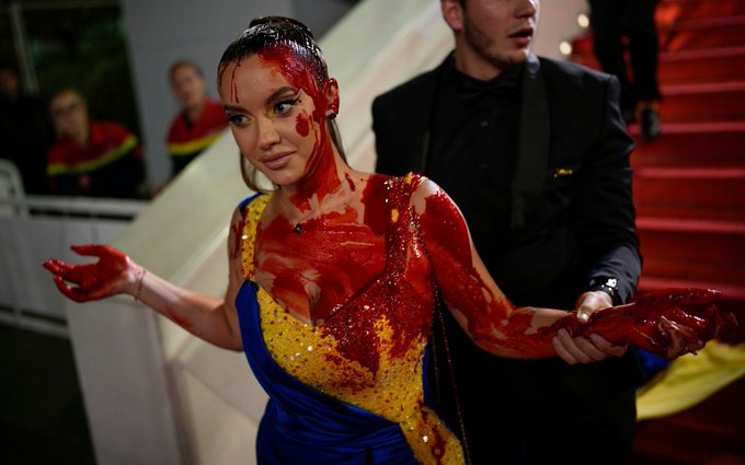 Woman in Ukrainian flag coloured gown spills fake blood on herself at Cannes red carpet; Watch video