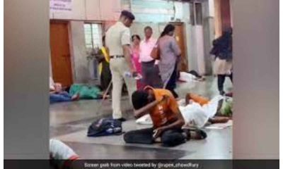 Railway policeman pours water on sleeping passengers at railway station to wake them up